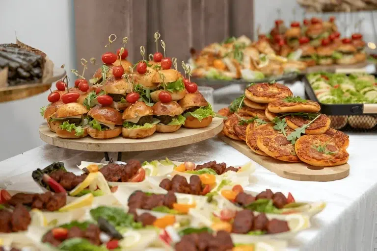 Table with Mini burgers and pizzas: Quick Delicious Appetizers New Years Eve