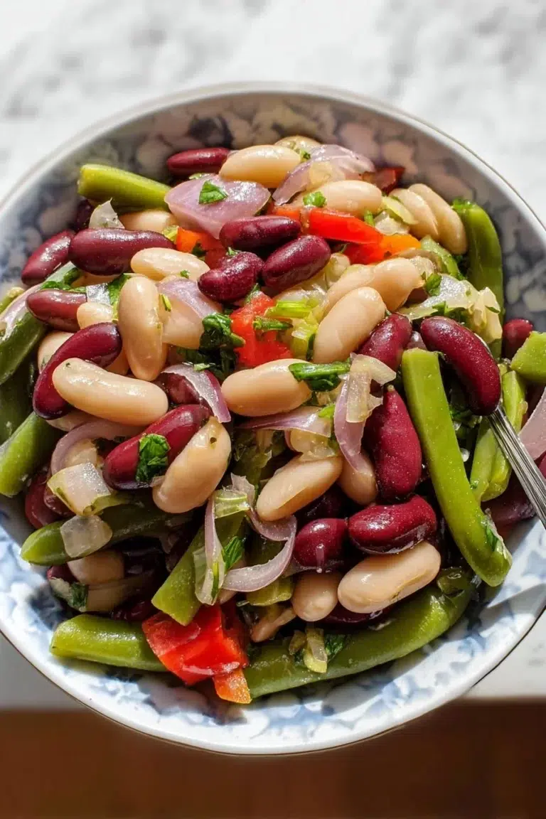A colorful plate of classic Three Bean Salad with a mix of beans and fresh veggies.