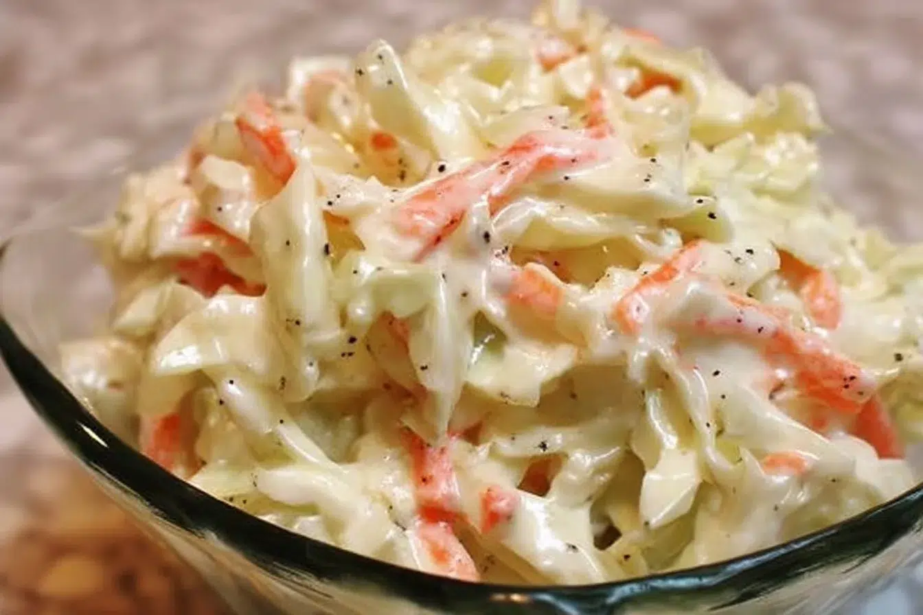 Bowl of creamy coleslaw dressing with fresh ingredients
